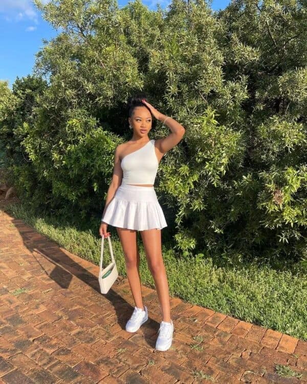 16 – All White Outfit: Asymmetrical White Crop Top, with Matching Tennis Skirt and White Sneakers