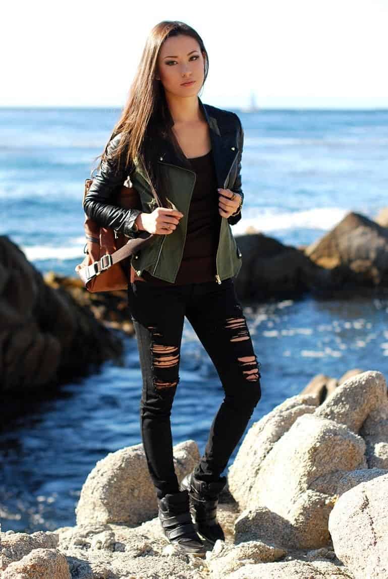 19 – Layer an All Black Outfit with a Green Jacket for Beautiful Travel Pictures