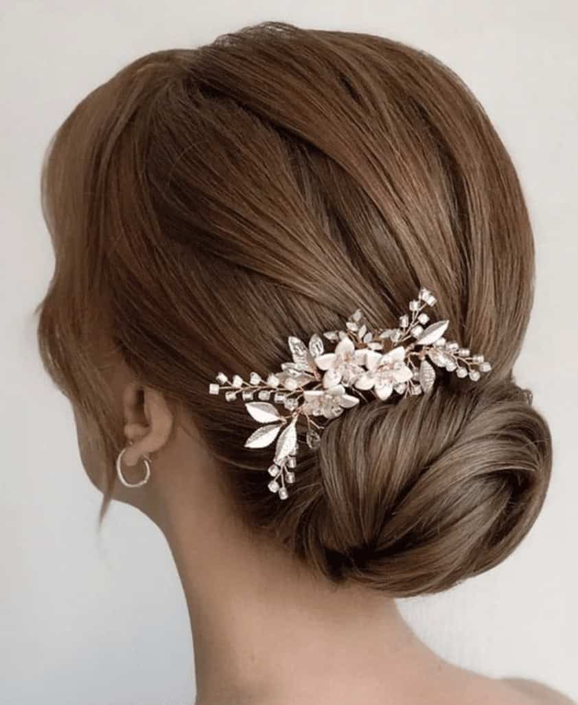 9 – Low Bun Hairstyle with Flower Hair Accessories