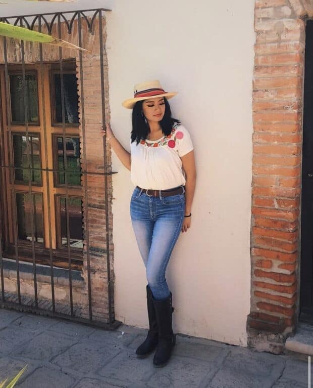 11 – Simple Ruched White Top With Bold Florals at the Neckline paired with Jeans and Calf-High Boots