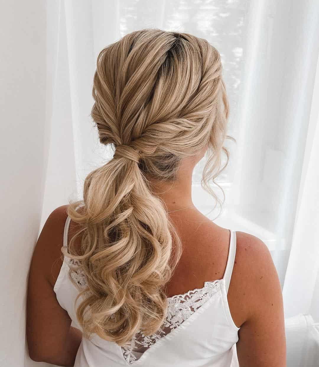 10 – Twisted Low Ponytail For Wedding Guest