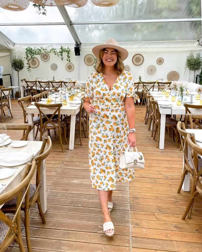 9 – White Dress With A V Neckline Printed with Cute Fruit Print And Matched With White Accessories