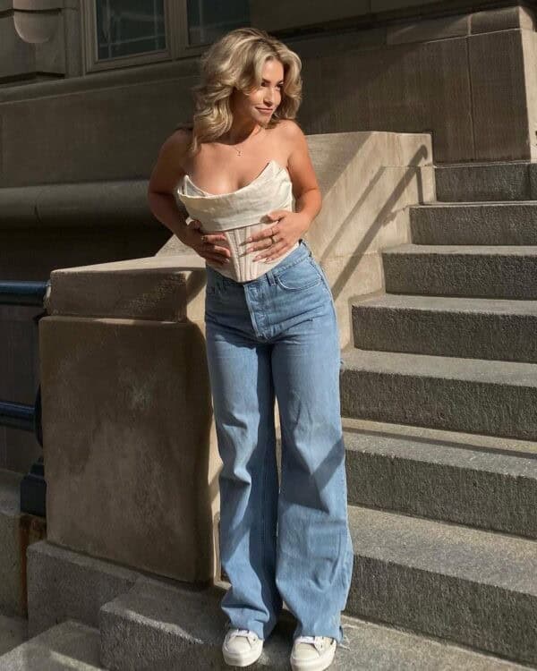 3 – White Corset Top With High Waisted Wide Leg Jeans Paired with Matching White Sneakers