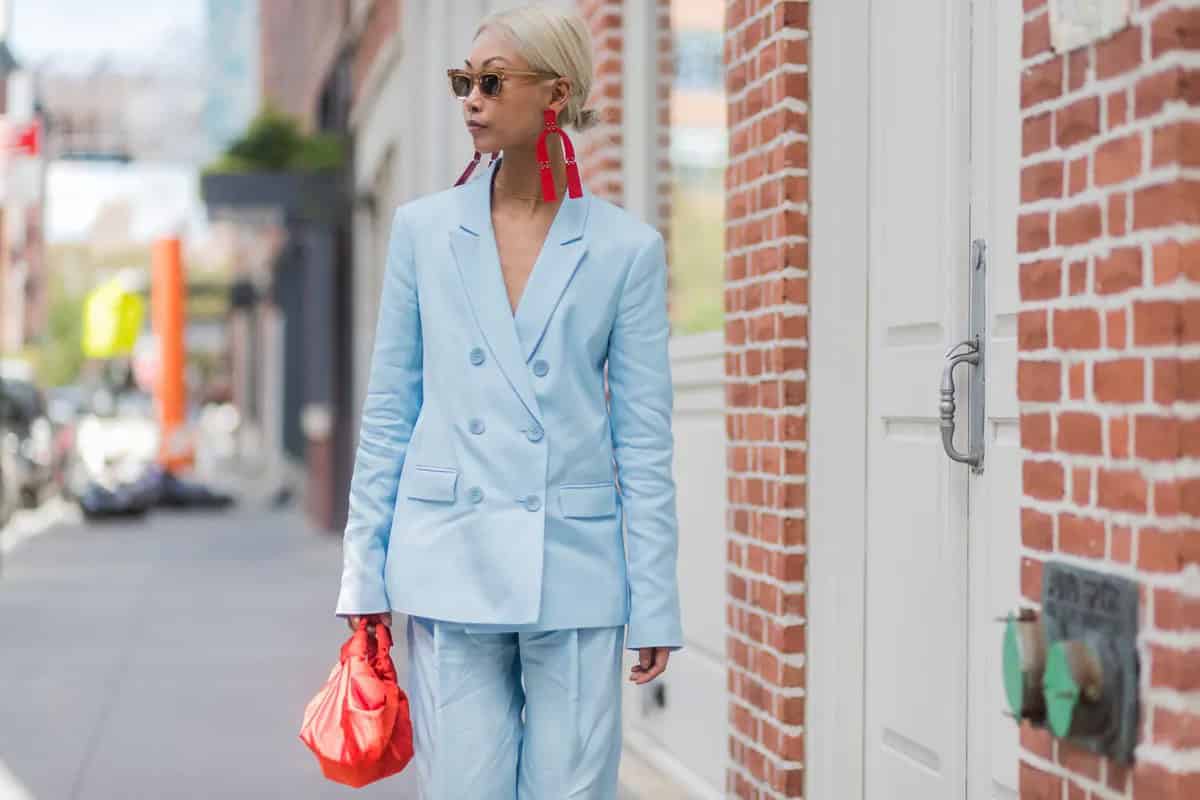 4 – Baby blue suit with red earrings and bag